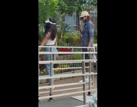 Girl jeans knee up pose garden flowers