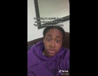Girl purple hoodie on brown couch talking