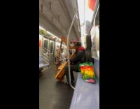 Submitter films man plays harp on subway