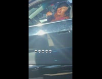 Woman in car eating entire pork chop