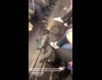 Passengers talks about liquid on subway floor