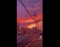 Lady shows off pretty sunset and colorful sky