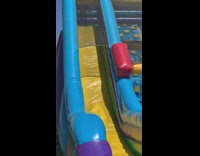 Little girl slides down inflatable bouncy house and scorpions at the bottom