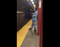 Cloud man in suit and blue face paint taps foot and talks to hand sock puppet