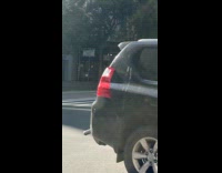 Mannequin in superman pose on taxi roof