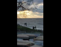 Girl split raise arm beach waves sunset
