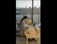 Timelapse of woman in long blue shirt writing