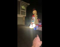Guy in yellow plaid flannel tackles Olaf snowman blow up decoration