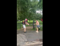 Men twisting picnic mat to remove rain water