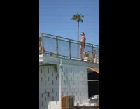 Man black briefs dramatic pose on the balcony