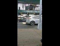 Shirtless guy pulls shopping carts down sidewalk 