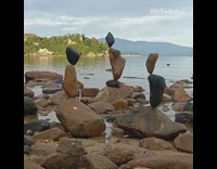 Guy stacks rocks into three towers 