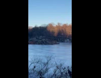 People ice skate on frozen water park