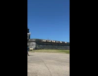 Woman stands near the edge of the castle barrier
