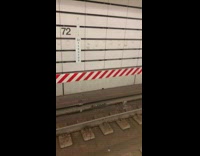 Handprints on subway station wall tracks