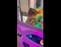 Girl likes ball gets inside claw machine