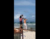 Shirtless man white pants dance on the beach