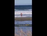 Old guy black shorts beach phone tripod 