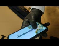 Man with a black glove opens phone by fingerprint lock