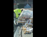 Two men clean up accident of cans spilled