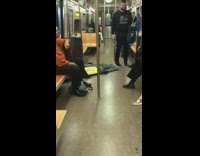 Pt. 2 Person sleeps on subway train floor with black tarp sheet over their body