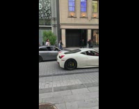 Woman on the convertible car films other car