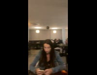 Two prawns on a stick raised at the restaurant table