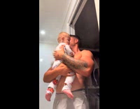 Dad tossing baby patting powder