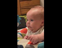 baby in chair overstimulated playing