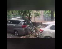 Collapsed wall gate crushes parked cars 