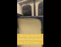 Guy brings mattress with fitted sheet onto subway 