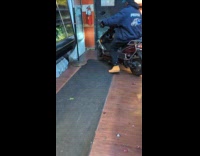 Store staff brings scooter motorcycle inside room