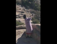 Woman takes picture of product in air at mountain
