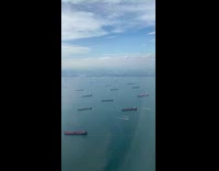 Ocean filled with cargo ships from plane view