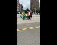 Three guys and kid play jenga outside 