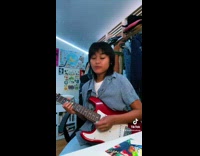 Girl playing sofia by clairo and burps on guitar 
