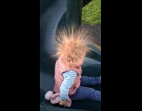 Little girl slides with hair spikes up