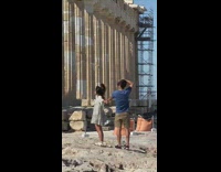 Girl grey dress hold hand pillar greece