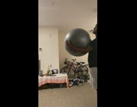 Guy throw exercise ball spin back to him