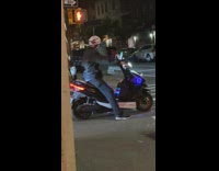 Guy on scooter has neon lights flashing 