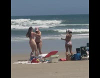 Two Ladies in Bikinis Partner Dance on the Beach for Video 