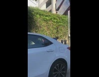 Pink shirt girl sidewalk parking meters wall