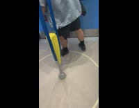 Man blue shirt stretches legs on subway train