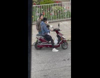 Couple rides on the scooter with baby