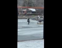 Man black jacket dances on frozen lake