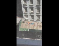 Guy sunbathes on wooden balcony 