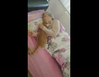 Grandma in bed with cat white blanket