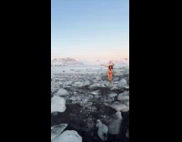 Woman red bikini dances on glacier with drone