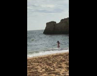 Woman moving arms around in beach picture