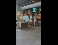 Two men danced with a drink inside the bar